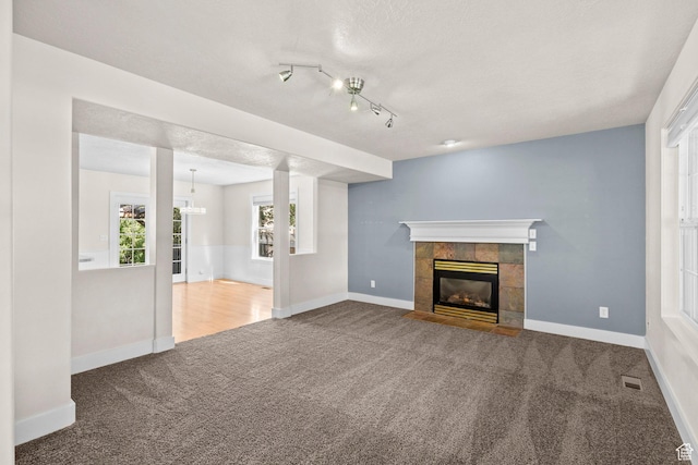 7861 N Tinamous Rd, Eagle Mountain, UT 84005 - unfurnished living room featuring carpet and a fireplace