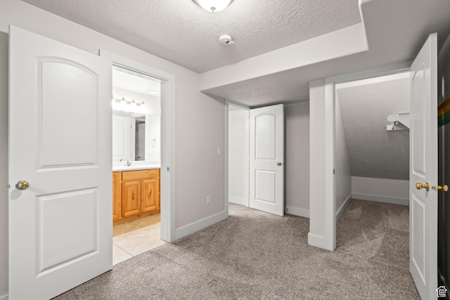 7861 N Tinamous Rd, Eagle Mountain, UT 84005 - unfurnished bedroom with a textured ceiling, light colored carpet, and ensuite bath