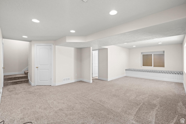 7861 N Tinamous Rd, Eagle Mountain, UT 84005 - finished below grade area with light colored carpet, recessed lighting, stairway, and a textured ceiling