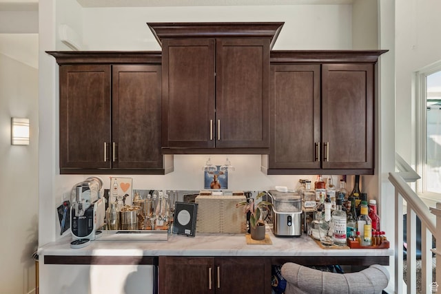 4937 W Daybreak Pkwy, South Jordan, UT 84009 - kitchen featuring dark brown cabinetry, plenty of natural light, and light stone countertops