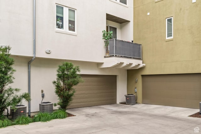 4937 W Daybreak Pkwy, South Jordan, UT 84009 - back of property with a balcony, stucco siding, a garage, and driveway