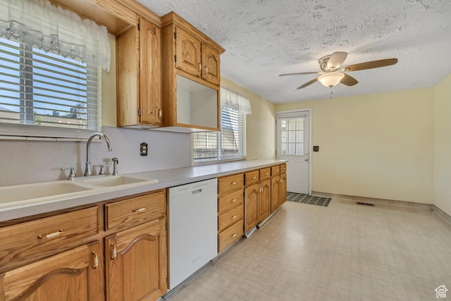 849 S 665 W, Woods Cross, UT 84087 - kitchen with white dishwasher, light countertops, a ceiling fan, a textured ceiling, and brown cabinetry