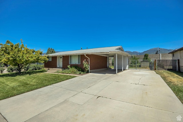849 S 665 W, Woods Cross, UT 84087 - single story home featuring concrete driveway, a carport, brick siding, and a mountain view