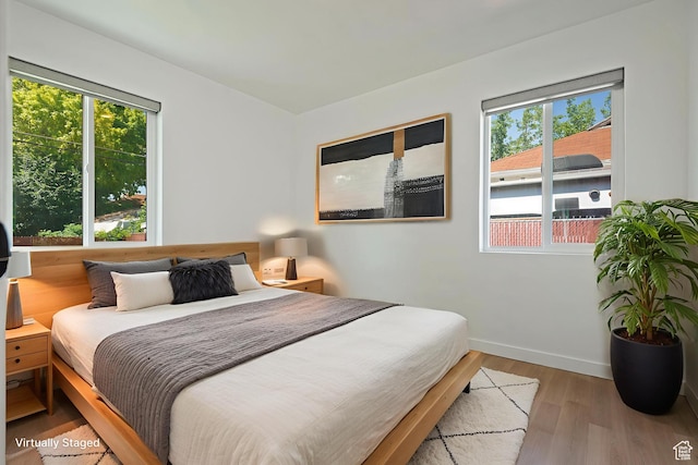 943 W Signora Dr, Salt Lake City, UT 84116 - bedroom with multiple windows and wood finished floors