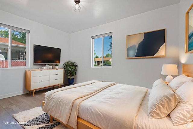 943 W Signora Dr, Salt Lake City, UT 84116 - bedroom featuring multiple windows and wood finished floors