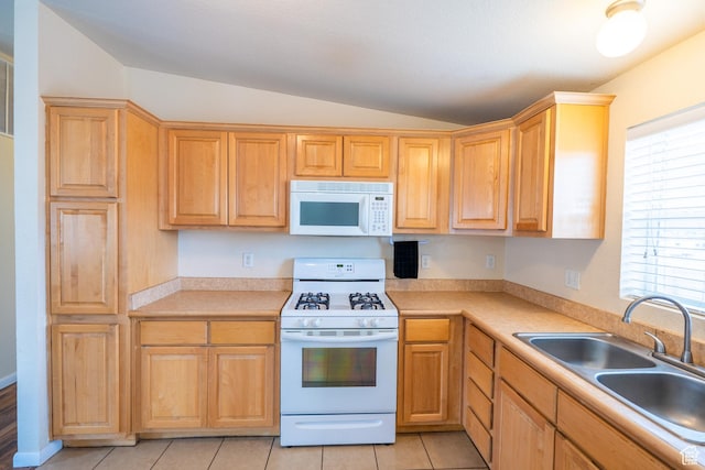 4568 Pueblo Verde Dr, Moab, UT 84532 - kitchen featuring white appliances, vaulted ceiling, light countertops, and light tile patterned floors