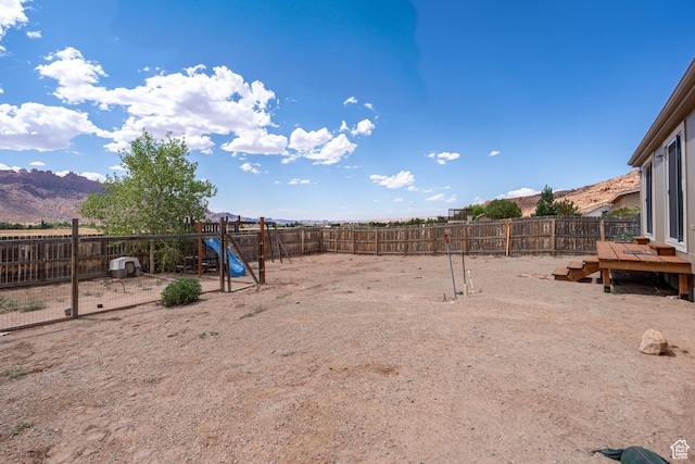 4568 Pueblo Verde Dr, Moab, UT 84532 - fenced backyard with a playground and a mountain view
