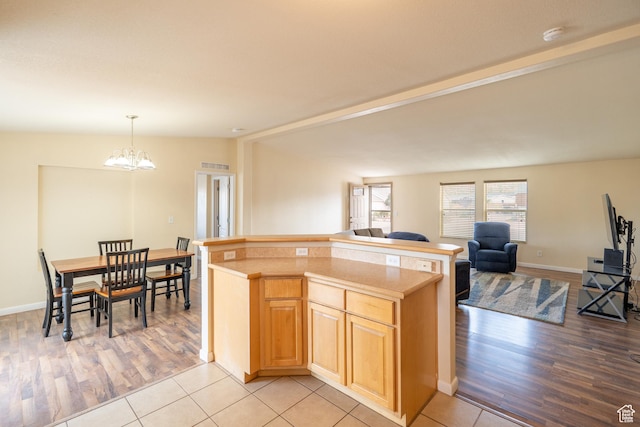 4568 Pueblo Verde Dr, Moab, UT 84532 - kitchen featuring open floor plan, light wood-style floors, a chandelier, light countertops, and hanging light fixtures