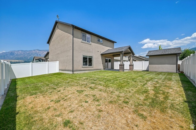 885 W 2150 N, Pleasant View, UT 84404 - back of house featuring stucco siding, a fenced backyard, and a mountain view