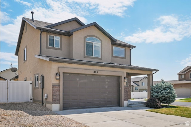 885 W 2150 N, Pleasant View, UT 84404 - traditional home with stucco siding, an attached garage, driveway, and a gate