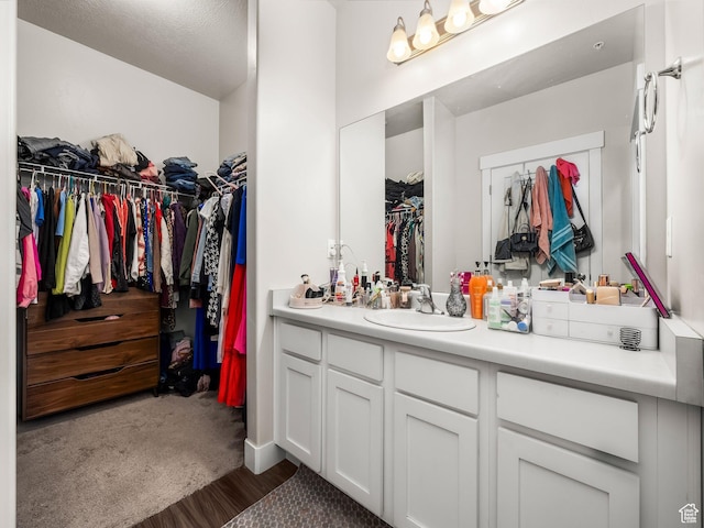 523 N 310 W, Vineyard, UT 84059 - bathroom featuring vanity, a spacious closet, and wood finished floors