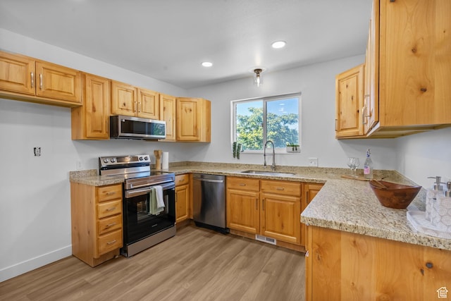 1455 N Amiron Way Unit D, Orem, UT 84057 - kitchen featuring stainless steel appliances, light wood-type flooring, recessed lighting, and light stone counters