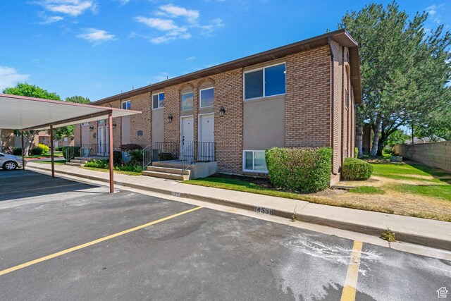 1455 N Amiron Way Unit D, Orem, UT 84057 - view of front of home with uncovered parking and brick siding