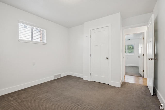 223 E 100 N, Bountiful, UT 84010 - unfurnished bedroom with dark carpet and baseboards