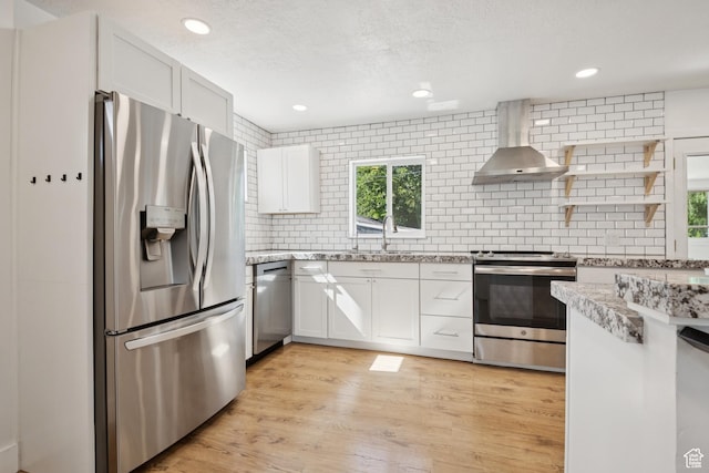 223 E 100 N, Bountiful, UT 84010 - kitchen with stainless steel appliances, wall chimney range hood, backsplash, white cabinets, and recessed lighting