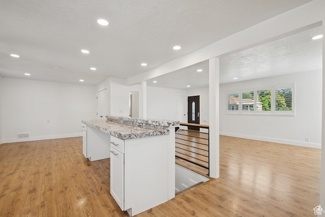 223 E 100 N, Bountiful, UT 84010 - kitchen featuring open floor plan, light wood-style floors, a center island, recessed lighting, and white cabinetry