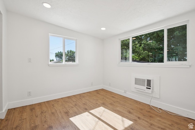 223 E 100 N, Bountiful, UT 84010 - unfurnished room featuring wood finished floors, a wall mounted AC, and recessed lighting