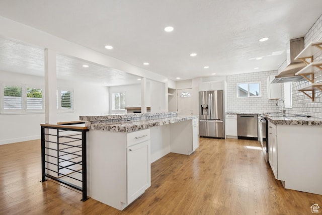 223 E 100 N, Bountiful, UT 84010 - kitchen with appliances with stainless steel finishes, a center island, light wood-style flooring, a breakfast bar, and recessed lighting