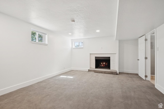 223 E 100 N, Bountiful, UT 84010 - unfurnished living room with a brick fireplace, carpet, recessed lighting, and a textured ceiling