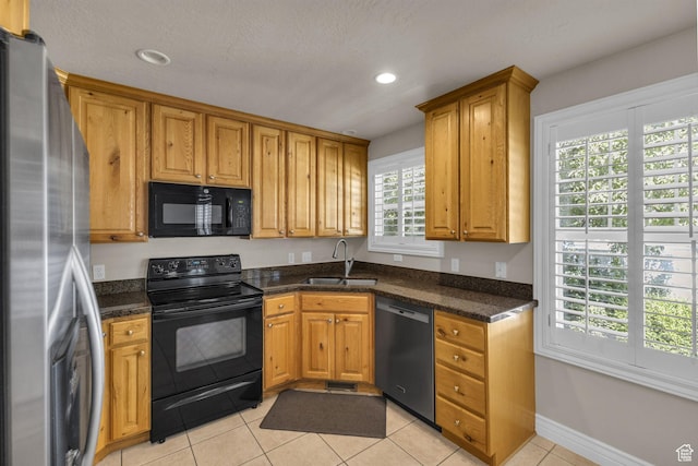 1082 E 370 N, American Fork, UT 84003 - kitchen with black appliances, recessed lighting, light tile patterned floors, brown cabinets, and dark stone counters