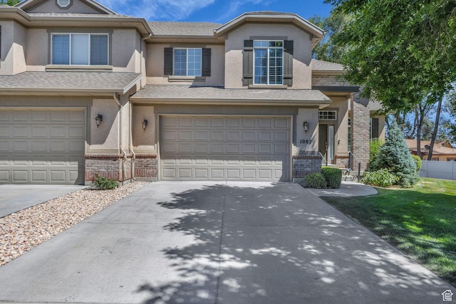 1082 E 370 N, American Fork, UT 84003 - view of front facade featuring stucco siding, a garage, driveway, and brick siding