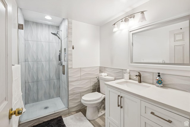 9355 S Peruvian Dr E, Sandy, UT 84093 - bathroom with tile walls, a shower stall, vanity, and recessed lighting