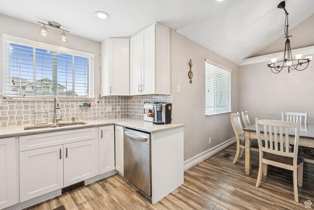9355 S Peruvian Dr E, Sandy, UT 84093 - kitchen with dishwasher, a chandelier, tasteful backsplash, light wood-style floors, and lofted ceiling