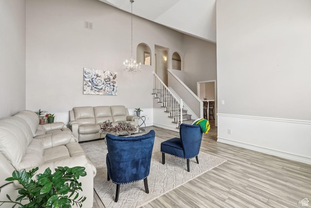 9355 S Peruvian Dr E, Sandy, UT 84093 - living area featuring a chandelier, wood finished floors, stairway, and high vaulted ceiling