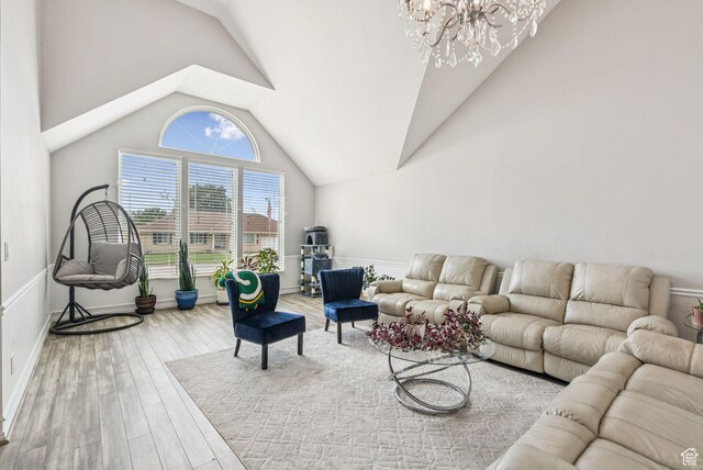 9355 S Peruvian Dr E, Sandy, UT 84093 - living area featuring lofted ceiling, a chandelier, and wood finished floors