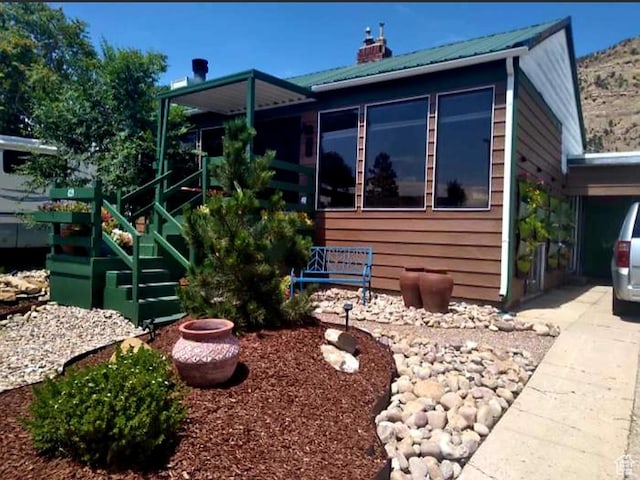 429 Edgehill Dr, Sunnyside, UT 84539 - view of front of house featuring a metal roof, a chimney, and stairway