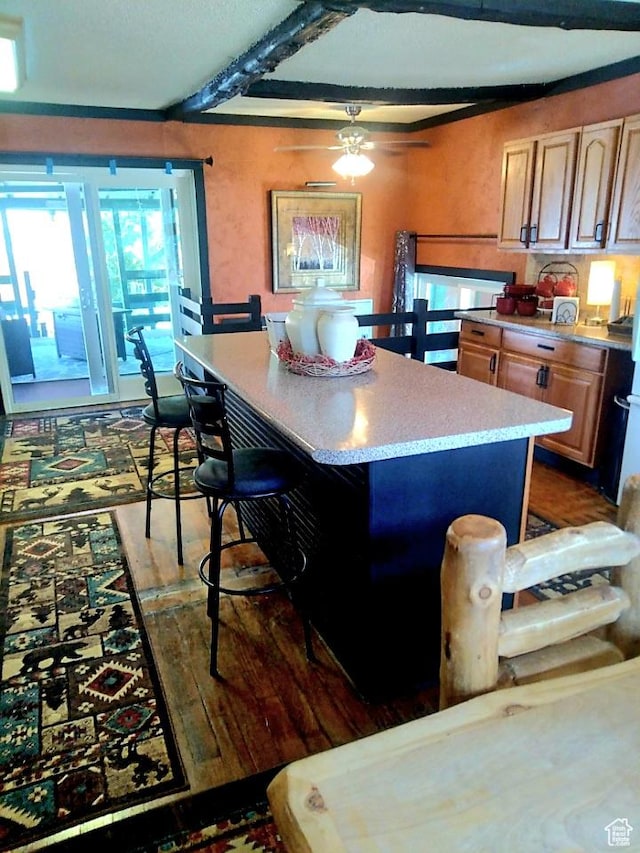 429 Edgehill Dr, Sunnyside, UT 84539 - kitchen with light countertops, light wood-style floors, a breakfast bar area, a center island, and a ceiling fan