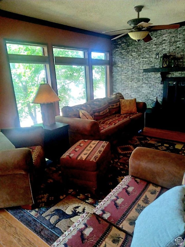 429 Edgehill Dr, Sunnyside, UT 84539 - living area featuring a textured ceiling, a ceiling fan, healthy amount of natural light, and wood finished floors