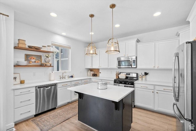 15181 S Sabre Pl, Bluffdale, UT 84065 - kitchen featuring appliances with stainless steel finishes, white cabinetry, light countertops, a center island, and recessed lighting