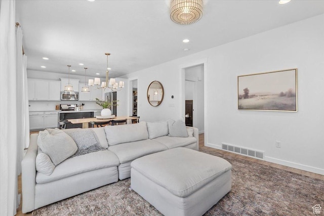 15181 S Sabre Pl, Bluffdale, UT 84065 - living area with recessed lighting, wood finished floors, and a chandelier