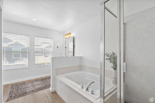 15181 S Sabre Pl, Bluffdale, UT 84065 - full bath featuring a bath, wood finished floors, a stall shower, and a textured ceiling