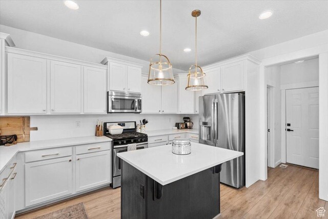 15181 S Sabre Pl, Bluffdale, UT 84065 - kitchen featuring appliances with stainless steel finishes, white cabinetry, recessed lighting, light countertops, and decorative light fixtures