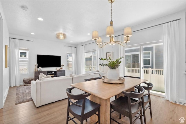 15181 S Sabre Pl, Bluffdale, UT 84065 - dining area with healthy amount of natural light, a chandelier, light wood-type flooring, and recessed lighting