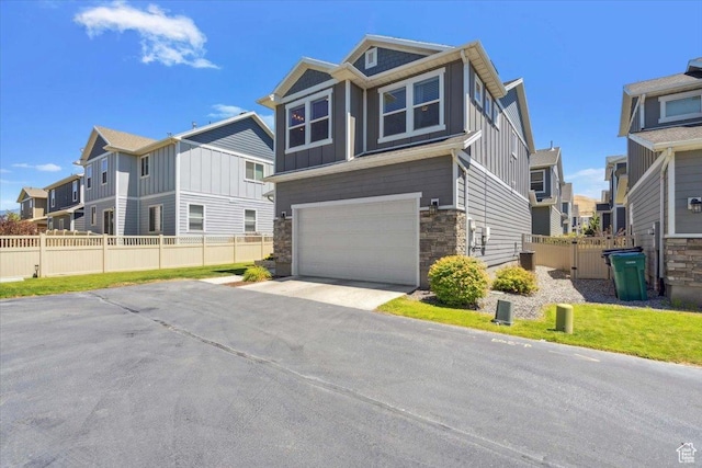 15181 S Sabre Pl, Bluffdale, UT 84065 - view of front of property with board and batten siding, stone siding, a residential view, a garage, and driveway