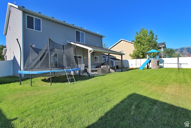 1464 W 800 S, Logan, UT 84321 - rear view of property with a trampoline, a fenced backyard, a playground, outdoor lounge area, and a patio area