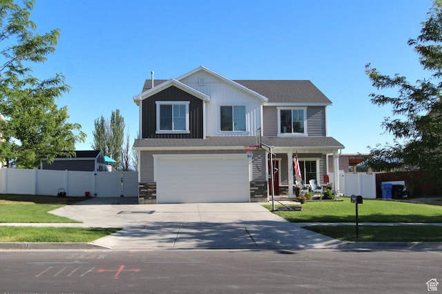 1464 W 800 S, Logan, UT 84321 - view of front facade featuring concrete driveway, a garage, stone siding, covered porch, and a gate