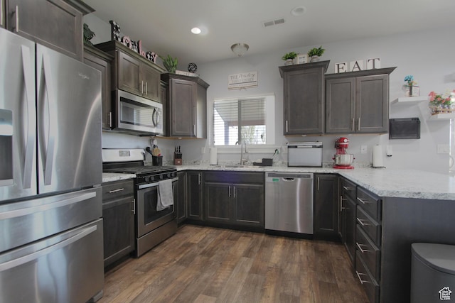 1464 W 800 S, Logan, UT 84321 - kitchen with stainless steel appliances, light stone counters, dark brown cabinetry, dark wood finished floors, and recessed lighting