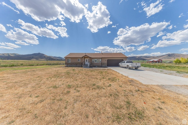 26551 N 8800 W, Portage, UT 84331 - ranch-style home featuring an attached garage, a mountain view, concrete driveway, and a front lawn