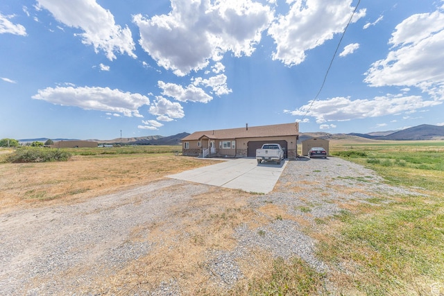 26551 N 8800 W, Portage, UT 84331 - view of front of home with concrete driveway, a garage, and a mountain view