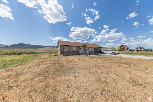 26551 N 8800 W, Portage, UT 84331 - view of front of property featuring concrete driveway, an attached garage, and a mountain view