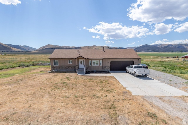 26551 N 8800 W, Portage, UT 84331 - ranch-style house featuring driveway, a mountain view, a garage, and board and batten siding