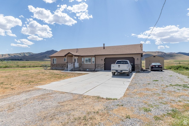 26551 N 8800 W, Portage, UT 84331 - single story home with driveway, stone siding, an attached garage, and a mountain view