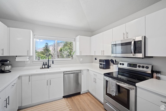 490 S 100 W Unit F305, Springville, UT 84663 - kitchen with stainless steel appliances, light countertops, light wood-style flooring, and white cabinetry