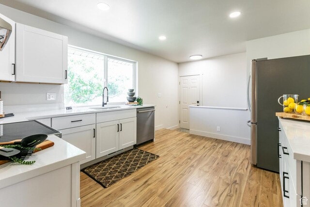 839 E Statice Ave S, Sandy, UT 84094 - kitchen featuring stainless steel appliances, white cabinets, light wood-type flooring, and recessed lighting