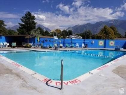 839 E Statice Ave S, Sandy, UT 84094 - community pool with a mountain view and a patio area