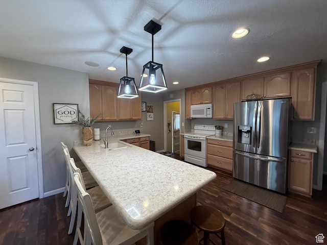 5140 S 2175 W, Roy, UT 84067 - kitchen featuring white appliances, a peninsula, dark wood-type flooring, light countertops, and recessed lighting